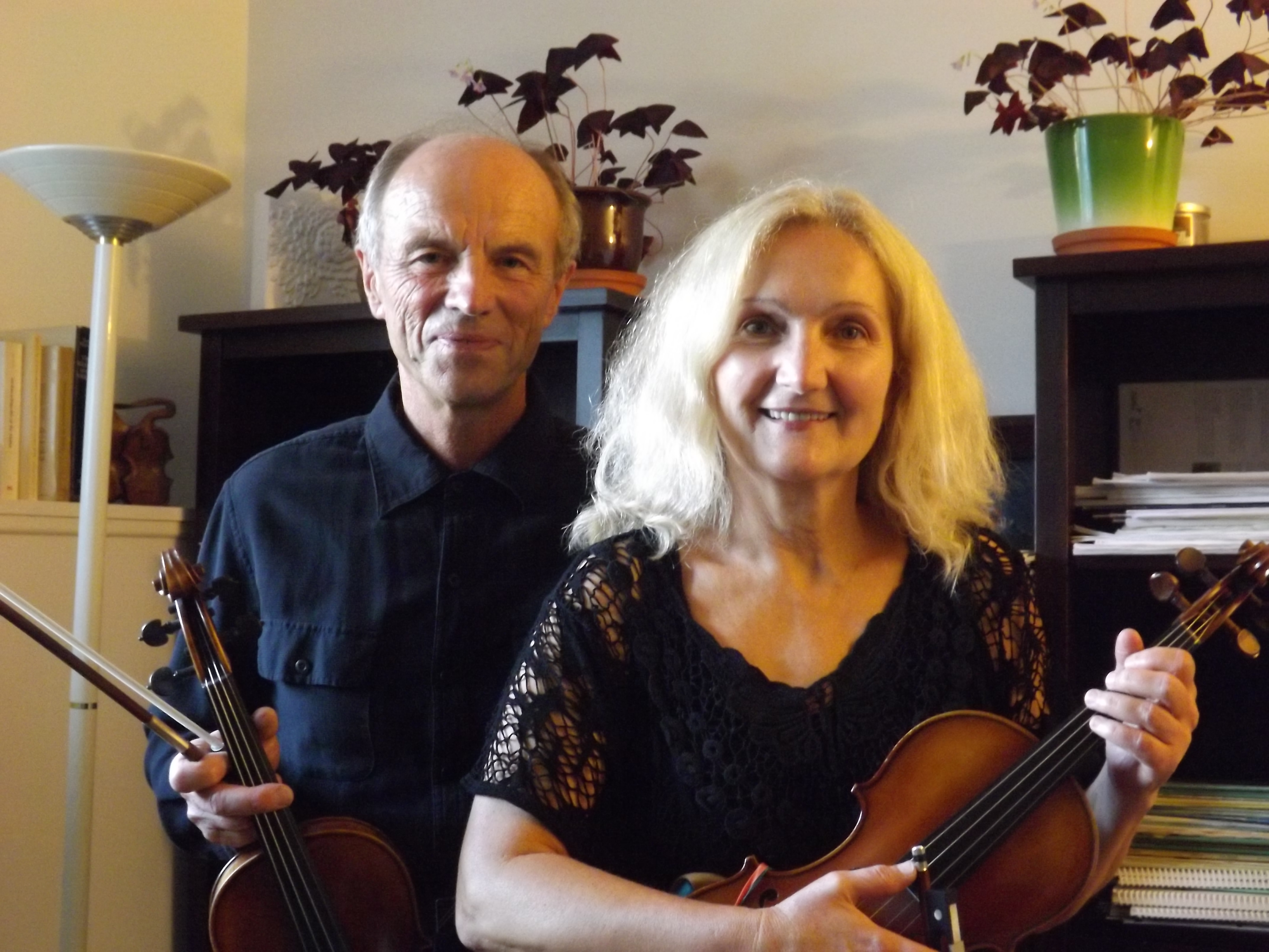 Aida and Hrvoje Tisler standing beside each other holding violins