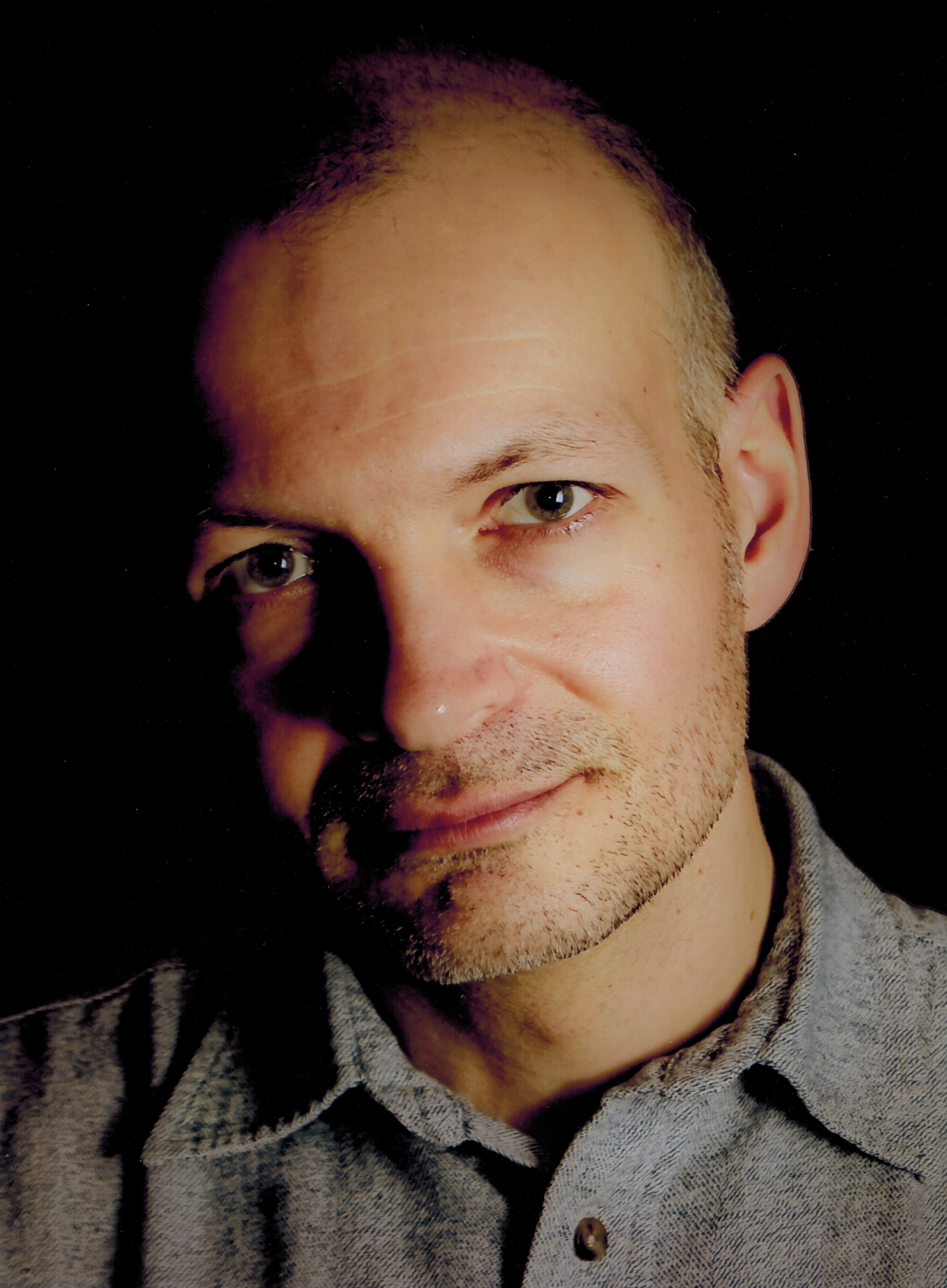 Close up headshot of Len Falkenstein against a black background