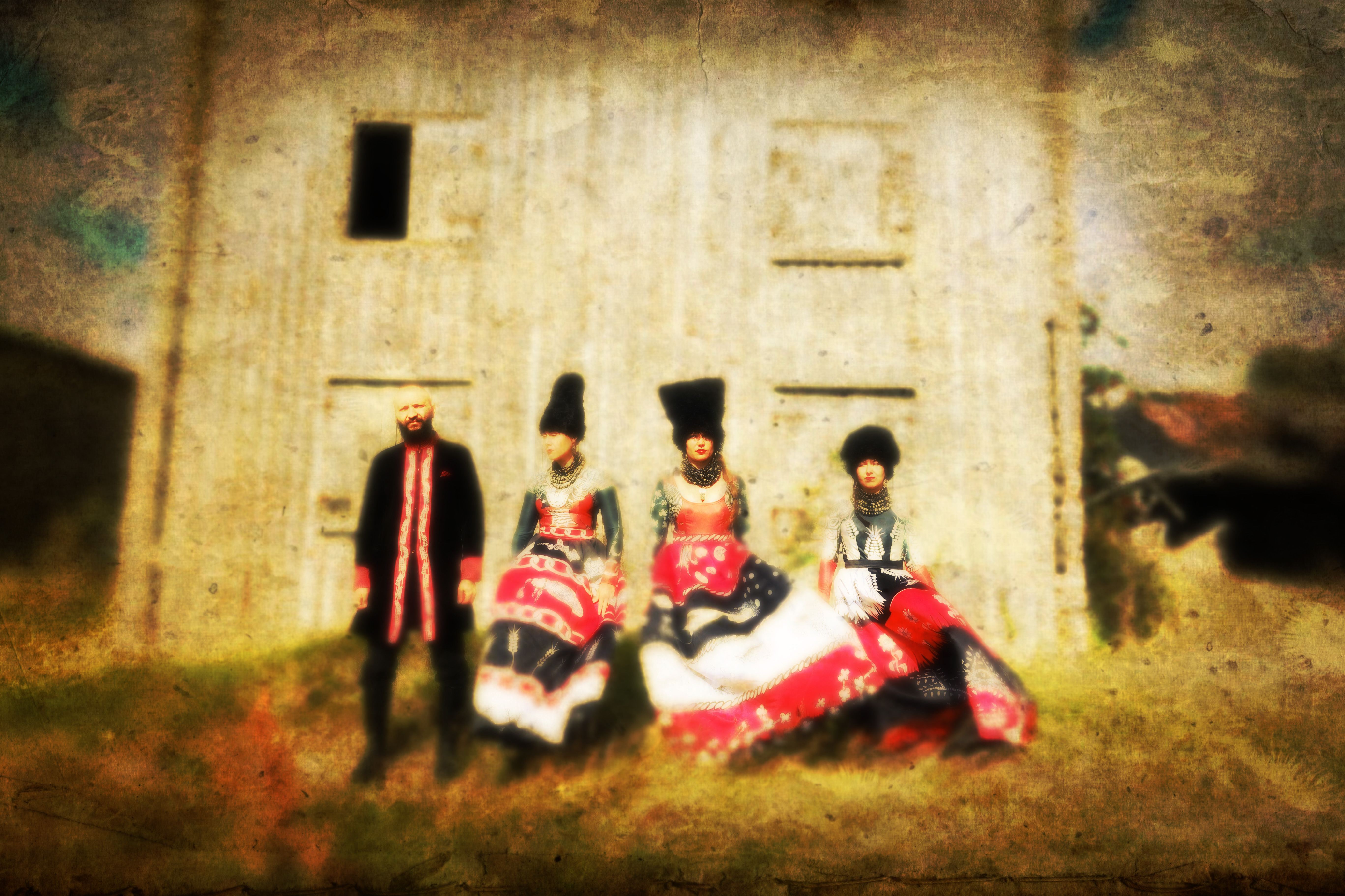 4 band members in traditional Ukranian clothing, standing against a light yellow background
