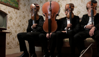 4 musicians holding string instruments in front of their faces