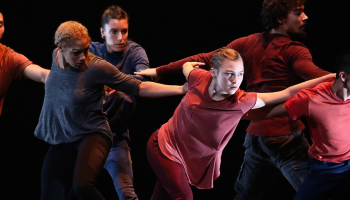 Dancers in Rubberband Dance with outstretched arms