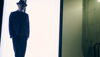 A man standing against a white backdrop.
