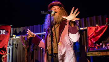 Ben Caplan on stage in Old Stock