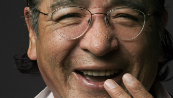 A photo of a Tomson Highway smiling.