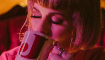 Jenn Grant sipping from a mug.
