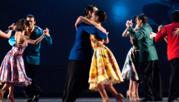 couples in colourful clothing dancing tango