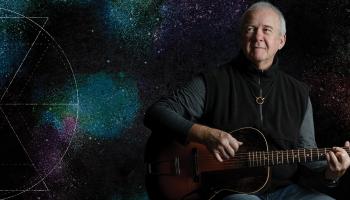 Murray McLauchlan holding a guitar.