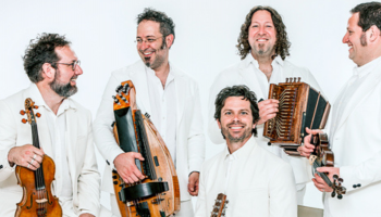 5 members of Vent du Nord dressed in white against a white background each holding instruments