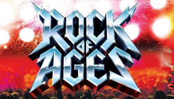 The words, 'Rock of Ages' in large silver lettering with bright lights shining behind them.