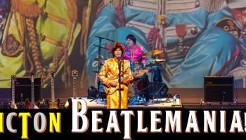 The words, 'Fredericton Beatlemania! in bold along the bottom of the image. Performers in colourful outfits on stage in front of a colourful backdrop. 