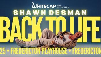 Shawn Desman laying on the ground in the foreground of the image. The words, 'Shawn Desman Back to life in yellow lettering behind him over a blue background.