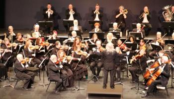 An image of the Fredericton Symphony Orchestra on stage with their instruments.