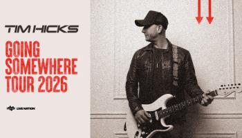 An image of Tim Hicks leaning against a wall holding his guitar, face turned to his right. The words, 'Tim Hicks Going Somewhere Tour 2026' in black and red over a pale cream background..