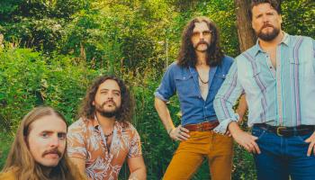 The Sheepdogs band members in a green forest