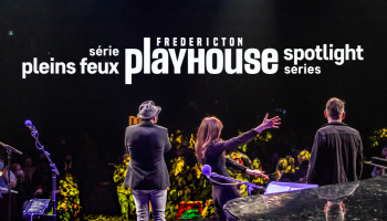 The Playhouse stage with several musicians facing the audience. 