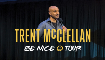 An image of Trent McClellan smiling and holding  a microphone. The words, 'Trent McClellan Be Nice Tour' in yellow and white lettering.