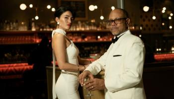 Two members of the orchestra are dressed up, facing the camera