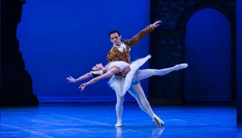 Two dancers strike a pose on stage