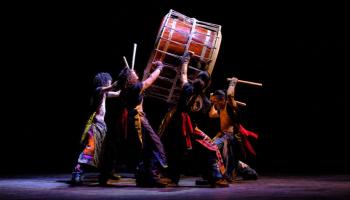 Members of Yamato Drummers hold up a large drum