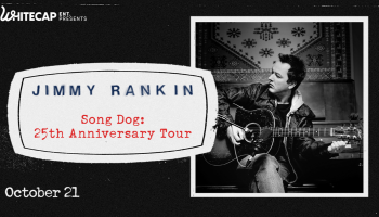 A black and white image of Jimmy Rankin looking off to the side while holding a guitar. The words, 'Jimmy Rankin Song Dog: 25th Anniversary' in blue and red lettering appear above him.
