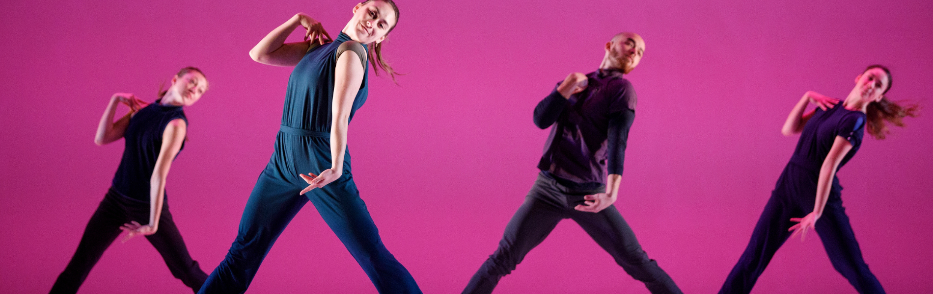 Four dancers in front of a pink background