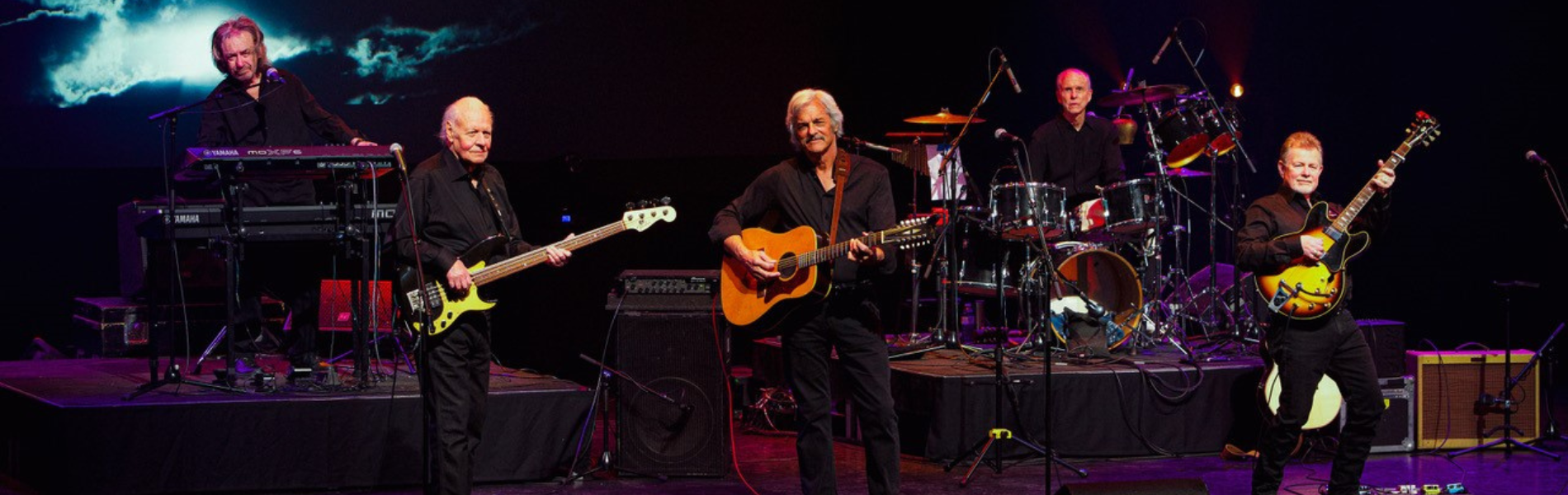 5 Musicians on playing various instruments on stage. 