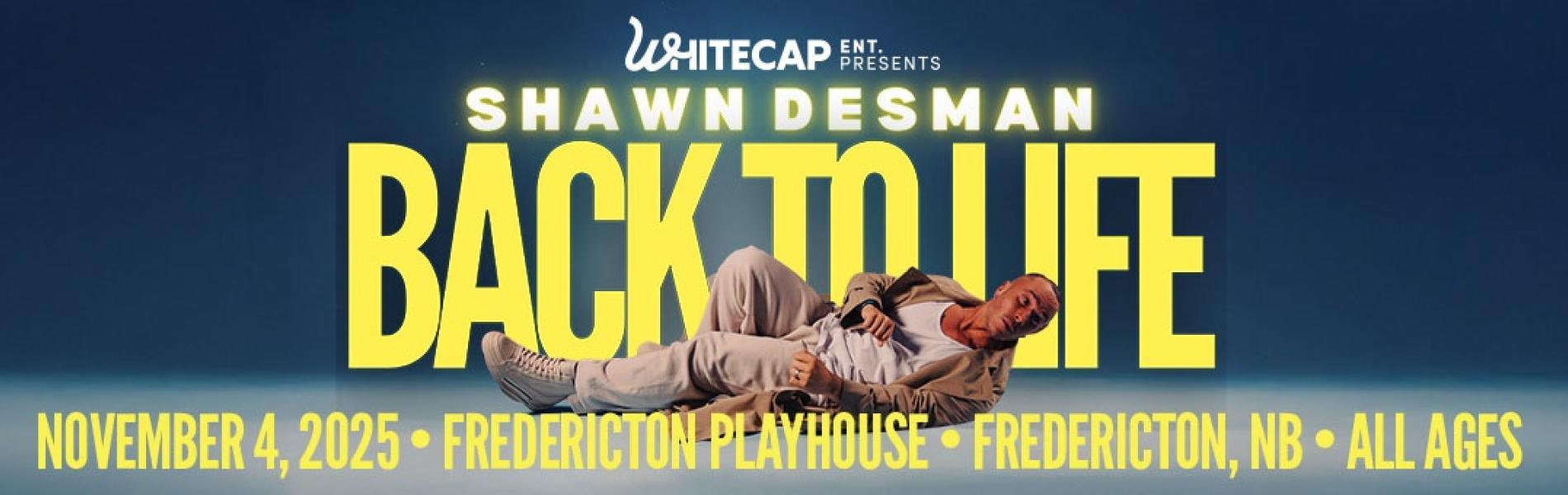 Shawn Desman laying on the ground in the foreground of the image. The words, 'Shawn Desman Back to life in yellow lettering behind him over a blue background.
