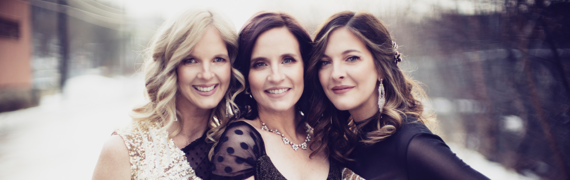 The Ennis Sisters centered with soft toned lighting.