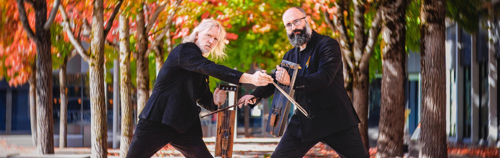 The two members of PUULUUP embrace outdoors.