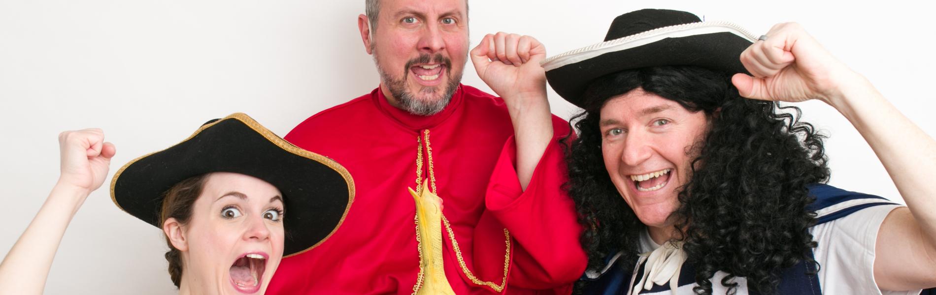 The three cast members of Dufflebag Theatre stand in historical costumes making silly faces