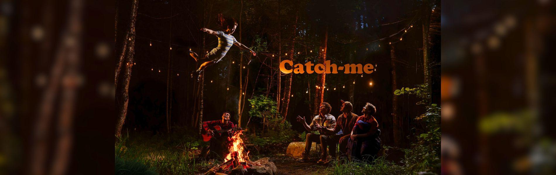 An acrobat flies high over a campfire