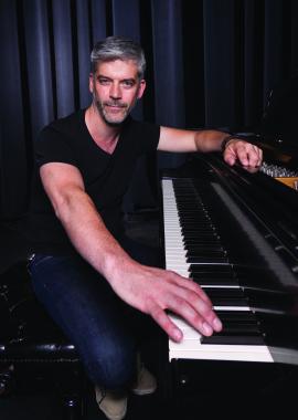 Michael Doherty sitting at a piano